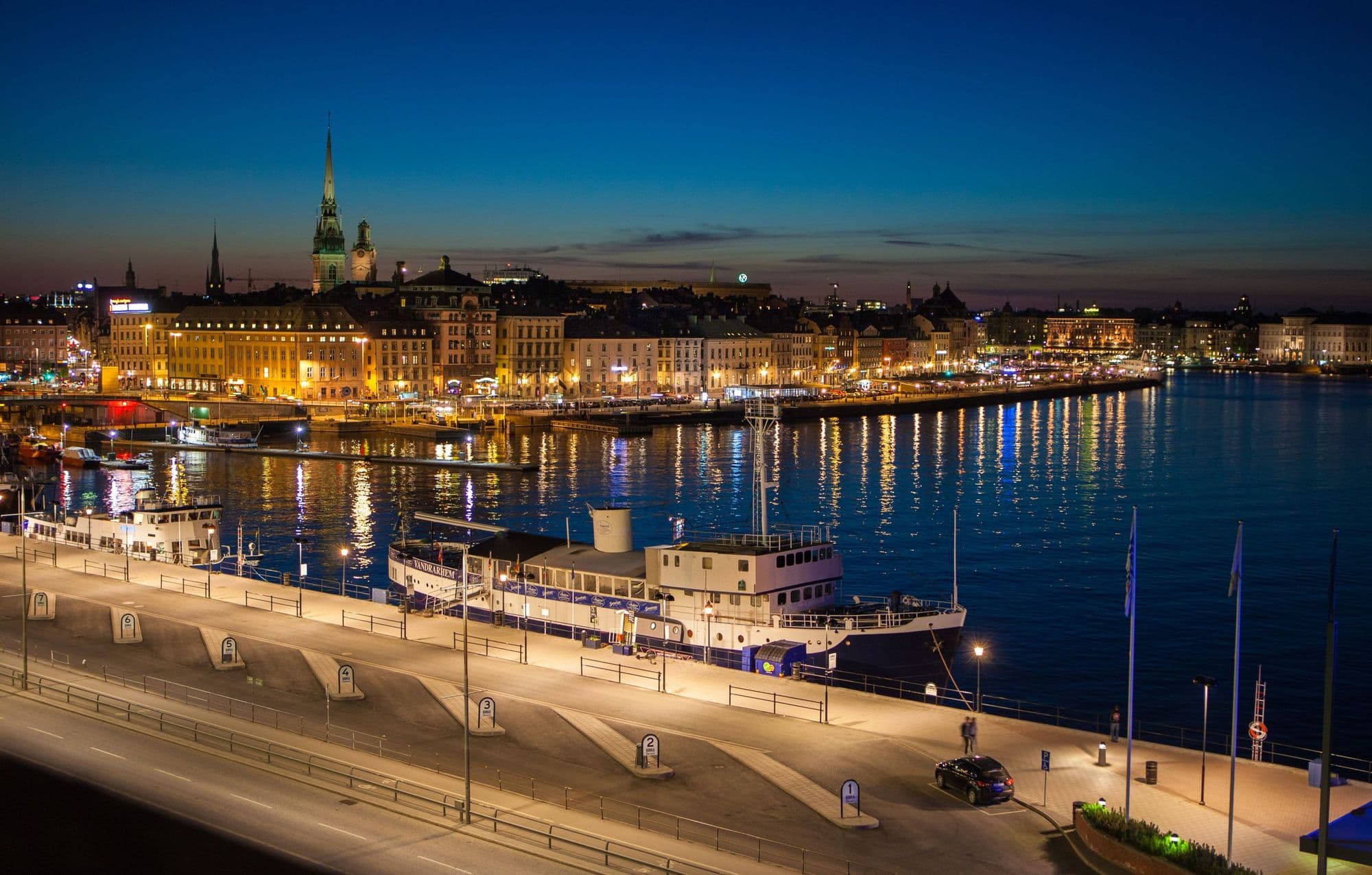 Stockholm's old town waterfront illuminated at night.