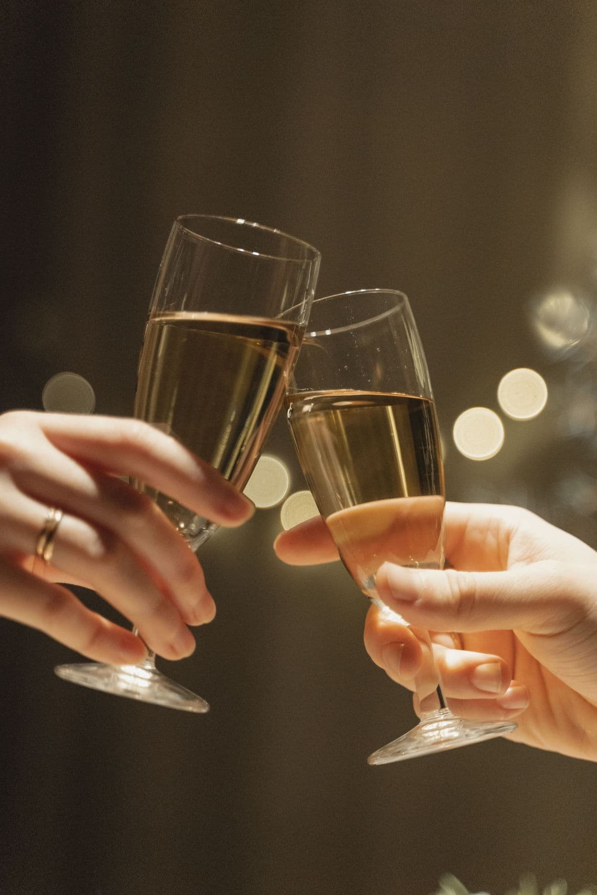 Two champagne glasses meeting in a toast.